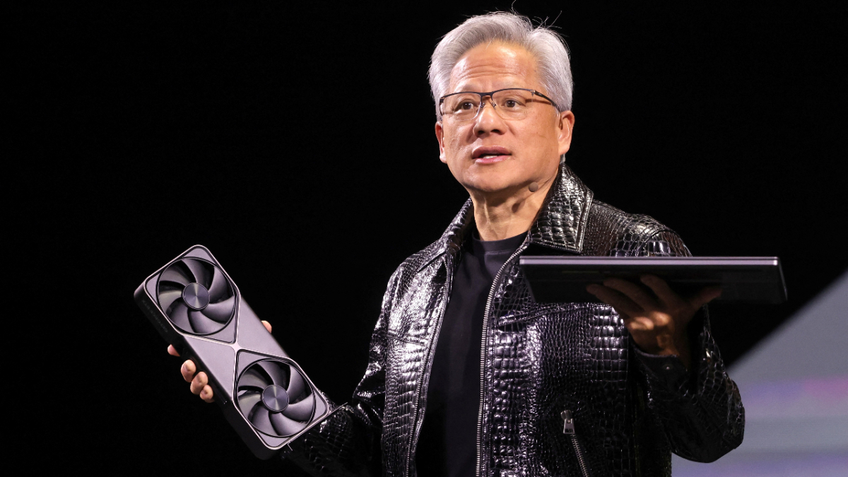 Jensen Huang holding the RTX 5090 at CES 2025.
